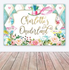 a sign that says charlotte's onederland with flowers and hats on it