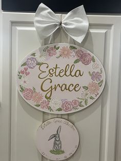 a door hanger that says, esttell grace and has a bunny on it