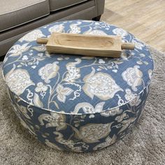 a blue and white ottoman sitting on top of a rug