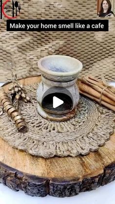 a wooden tray with some cinnamon sticks and a bowl on top of it that says make your home smell like a cafe