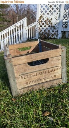 an old wooden crate sitting in the grass