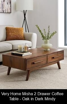 a living room with a coffee table and couch in front of a large window that reads very home misha 2 drawer coffee table oak in dark mindy