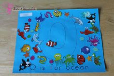 the letter o is for ocean with sea animals and fish on it's surface