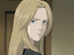 a blonde haired woman with long hair standing in front of a door looking at the camera