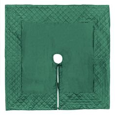 a green quilted square with a button on the center