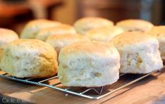 some biscuits are cooling on a rack and ready to be baked in the oven for consumption