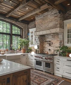 a kitchen with an oven, sink and counter tops in front of a large window