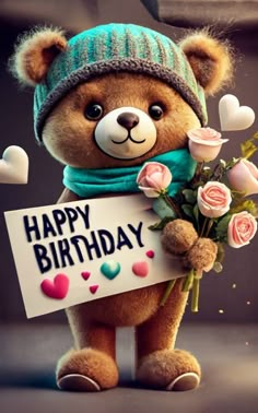 a teddy bear holding a happy birthday sign with roses in it's paws and wearing a knitted hat