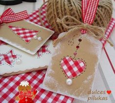 some tags and twine on a table with red gingham checkered cloth