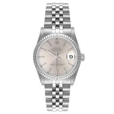 Ladies Midsize Rolex 31mm DateJust Stainless Steel Watch with Silver Dial and Fluted Bezel. Pre-Owned SN# L35**** Brand: Rolex. Gender: Ladies. Dial Color: Silver. Crystal: Sapphire. Bezel: Fluted Bezel. Condition: Very Good. Model Number: 68274. Case Dimensions: 31mm. Metal Type: Stainless Steel. Movement: Self-Winding (Automatic). Bracelet: Oyster Bracelet / Stainless Steel. Box / Certificate: Rolex Box / Certificate of Authenticity. Service Warranty: One (1) Year Limited Service Warranty. Elegant Silver Jewelry And Watches With Date Display, Classic Silver Jewelry And Watches With Date Display, Silver Formal Watch Bands, Silver Watch Bands For Formal Occasions, Formal Silver Watch Bands, Elegant White Gold Watch Bands With Date Display, Rolex 31mm Datejust, Zenith Watches, Rolex Watches Women