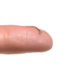 a finger with a tiny diamond on it