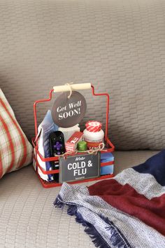 an open suitcase sitting on top of a bed next to a pillow and throw pillows