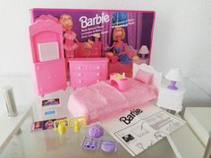 a barbie doll's bedroom with furniture and accessories on a table in front of a magazine