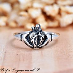 Anatomical Heart Hands Ring | Solid 925 Sterling Silver Gothic Style Ring | Womens Silver Ring | Halloween Theme Jewelry | Hands Heart Ring * Height: 10mm * Solid 925 Sterling Silver * Oxidized * Ring box included Processing and Shipping Details Ready to ship within 1-2 business days. USPS First Class mail is used for standard shipping. A tracking number is provided via email when the package is shipped. Faster shipping option is available.  Maintenance  Cleaning/Polishing - It is recommended to use a jewelry polishing cloth to clean silver jewelry.  It is also recommended to use jewelry cleaning solution every few months. Care - Proper maintenance is needed for color plated rings. Avoid contact with strong chemicals, household cleaning products, strong personal care products (lotion, perf Oxidized Ring, Cleaning Silver Jewelry, Jewelry Cleaning Solution, Anatomical Heart, Heart Hands, Hand Ring, Halloween Theme, Gothic Style, Ring Box