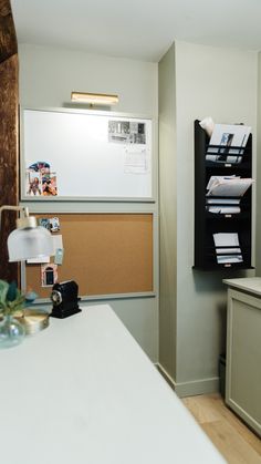 a white counter top sitting in a kitchen next to a wall mounted dry eraser