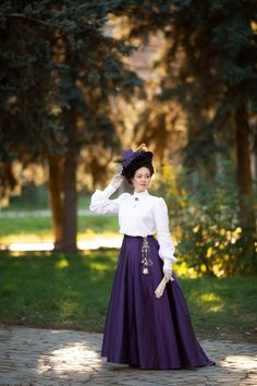 Fan skirts or umbrella skirts came into fashion starting in 1894 and were very popular until the end of the 19th century.   A simple cut in the form of wedges and  a narrow waist created an A-line silhouette that kept balance with the fashionable gigot sleeves that time. Skirts were simple and laconic often with a contrasting belt. The bodices of ball or walking costumes, as a rule, were richly decorated and had large gigot sleeves. Progressive ladies of the 19th century also wore this type of skirts with white shirts. The skirt is fitted around the hips with darts, which has much more pleating in the back and fullness in the hem. The skirt is made of ink-violet synthetic smooth taffeta, has a hook-and-eye closure at the back, a placket in the cut hidden by pleats. The hem of the skirt is Victorian Petticoat For Costume, Fitted Vintage Skirt With Historical Design, Vintage Costume Gathered Skirt, Vintage Gathered Skirt For Costume, Vintage Full Skirt For Costume, Costume Full Gathered Skirt, Victorian Style Fitted Full Skirt, Costume Full Skirt With Gathered Details, Vintage Flared Skirt For Formal Occasions