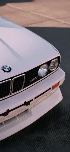 the front end of a white bmw car