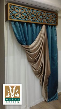 the curtain is hanging on the side of the wall with an ornate design in gold and blue