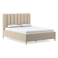 an image of a bed with white sheets and beige headboard on the bottom side