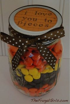 a jar filled with lots of candy sitting on top of a table