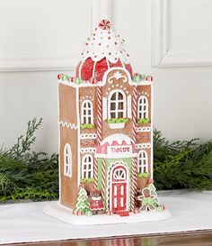 a gingerbread house is decorated with candy canes