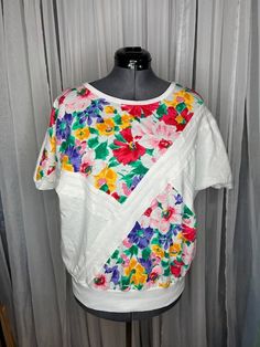 t-shirt vintage 1980s chevron floral bright dolman sleeve size 40 small stain on the back of the left sleeve. in otherwise excellent condition.  Be aware that vintage sizes may vary from modern standard sizes. See the sizely chart in the product photos for full measurements. The measurements are the most accurate gauge of the garments size. chest, waist and hip measurements are taken laying flat and then doubled. all measurements are approximate.  Vintage items are carefully inspected and I do m Easter Sale, Lace Collar, Night Shirt, Product Photos, Graphic Tees Women, Sheer Lace, Dolman Sleeve, Summer Wear, Womens Clothing Tops