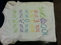 a white t - shirt with words written in different colors and numbers on the front