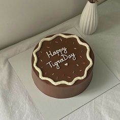 a chocolate birthday cake sitting on top of a table