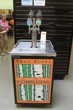 a water dispenser sitting on top of a metal counter in a store