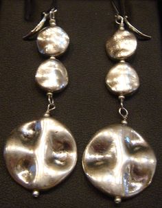 These earrings are light weight. The disks are high quality pewter connected with sterling silver eye and head pins. The Lever back ear wires are also Pewter. length is 3 inches and widest disk is 1 inch wide.  Free shipping on orders totaling $35 or more. Aggregate, multiple item,  orders of $35 or more will be given free shipping at check out! Happy shopping.  Free shipping only to addresses inside USA, including AK, PR and Hawaii Silver Eye, Head Pins, Pierced Earrings, Earings Piercings, Ear Wires, Jewelry Earrings Dangle, Etsy Earrings, Dangle Drop Earrings, Dangle Earrings