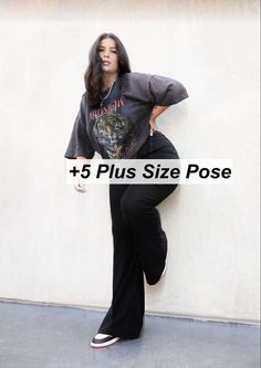 a woman leaning against a wall with her hands on her hips and the words, plus size pose