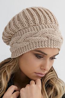 a woman wearing a beige knitted hat