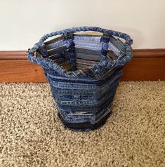 a blue vase sitting on top of a carpet covered floor