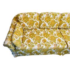 a yellow and white floral couch on a white background