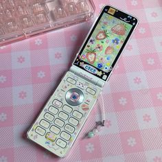 a cell phone sitting on top of a pink table