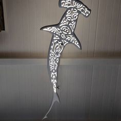 a paper cut shark hanging from the ceiling