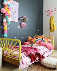 a child's bedroom decorated in pink and yellow