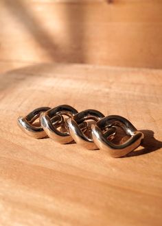 three metal rings on top of a wooden table