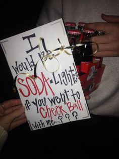 someone holding up a sign that says i love you, soda lights as if you went to cheer ball with me?