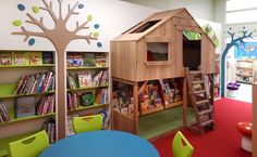 a children's library with bookshelves and ladders