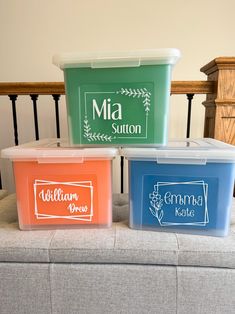 three plastic containers with labels on them sitting on a bench