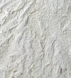 the texture of white paint is shown in close up, with small footprints on it