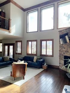 a living room filled with furniture and windows