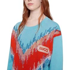 Opulent details, like glimmering feather and drop appliques, wrap around the shoulders of this cotton sweatshirt.Light blue felt cotton jersey with red maxi chevron motif.Embroidered beads.Gucci in SEGA fontCrewneck.Oversize fit.Composition: Cotton 100%Made in Italy. Gucci Blue Casual Sweater, Gucci Casual Blue Sweater, Casual Blue Gucci Sweater, Gucci Embroidered Logo Long Sleeve Sweatshirt, Gucci Blue Long Sleeve Sweater, Blue Long Sleeve Gucci Sweater, Gucci Crew Neck Sweatshirt For Fall, Gucci Casual Cotton Sweater, Gucci Long Sleeve Tops With Embroidered Logo