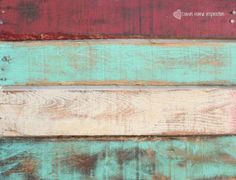 an old wooden board with different colors and patterns