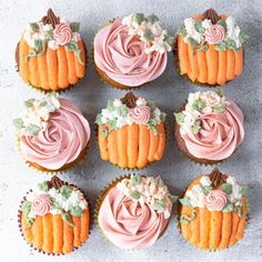 nine cupcakes with frosting and flowers on them are arranged in a circle