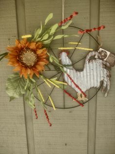 a sunflower sitting on top of a metal rack next to a wooden wall hanging