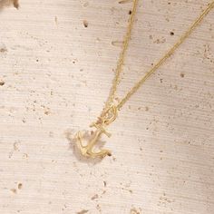 The Anchor Necklace is a delicate yet powerful piece, symbolizing strength and stability. Its minimalist anchor pendant offers a refined elegance, making it perfect for layering or wearing solo. This timeless design brings a sense of balance and strength to your everyday style. - Made in 14k solid gold - Pendant: 10.55x12.10 mm / 0.41x0.47 inches - Pendant Thickness: 1.44 mm / 0.05 inches - This product comes with iconic Norm Jewels gift box 14k Gold Anchor Necklace As Gift, Gold Anchor Jewelry Gift, Gold Anchor Pendant, Elegant Yellow Gold Anchor-shaped Necklaces, Anchor Pendant, Anchor Necklace, Signet Ring, Ring Bracelet, Gold Pendant