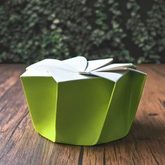 an origami box sitting on top of a wooden table