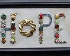 there are many different types of bracelets on display in a shadow box that is black and white